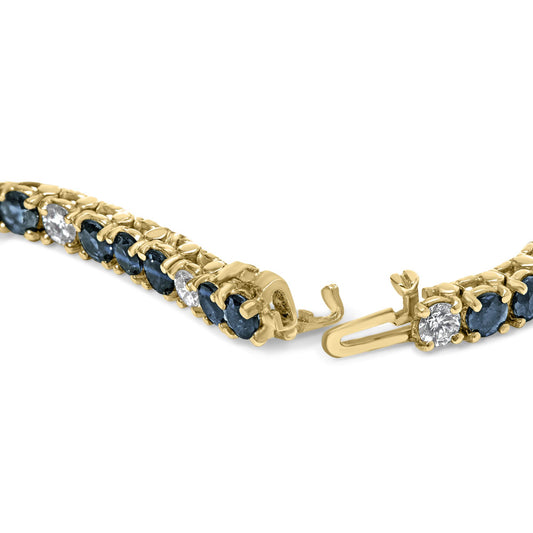Close-up angled view of a yellow bracelet with alternating round blue and white gemstones in 4-prong settings, showing the open clasp.