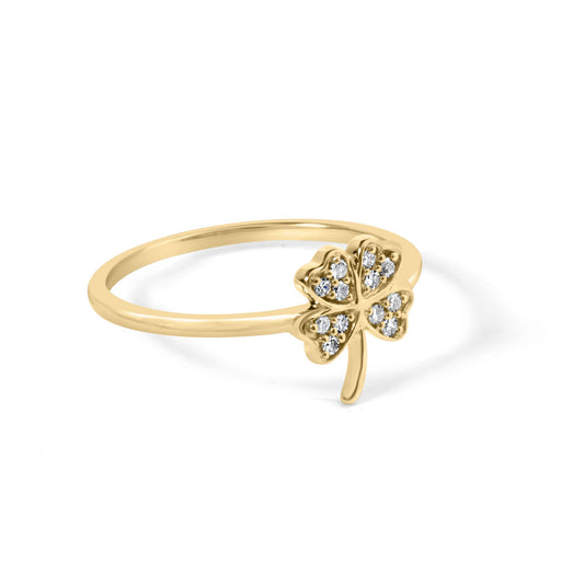 Yellow metal ring with a four-leaf clover design accented with round white gemstones, shown at an angled close-up.