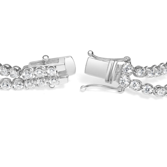 Close-up front angled view of a white metal bracelet with two rows of round white gemstones in 4-prong settings and a box clasp.