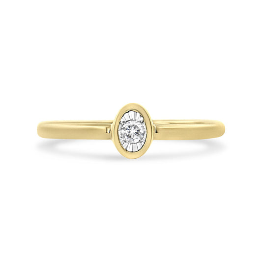 Front view of a yellow ring with a round white gemstone set in an oval setting.