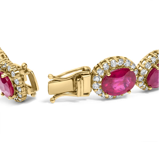 Close-up angled view of a yellow bracelet featuring oval red gemstones surrounded by round white gemstones in a four-prong setting, showing the clasp open.