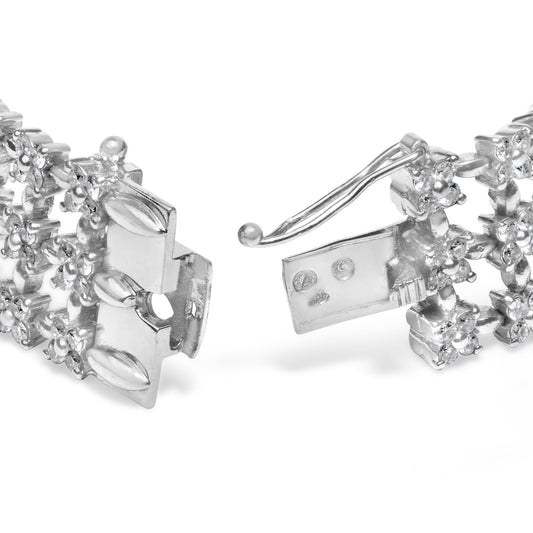 Close-up front angle of a white metal bracelet with round white gemstones in 4-prong settings, showing the clasp open.