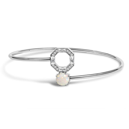 White metal bangle bracelet shown from the front on a white background, featuring a round white opal gemstone below an octagonal arrangement of white round and baguette gemstones in prong settings.