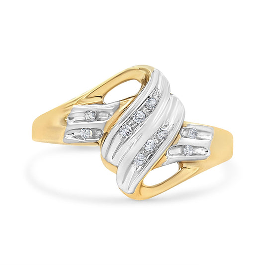 Two-toned ring with round white gemstones in channel setting, shown at a slight angle.