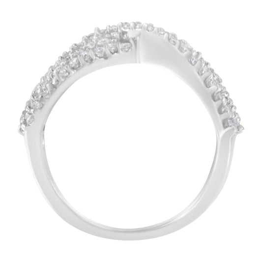 Close-up front view of a white metal ring with multiple round white gemstones in prong settings.