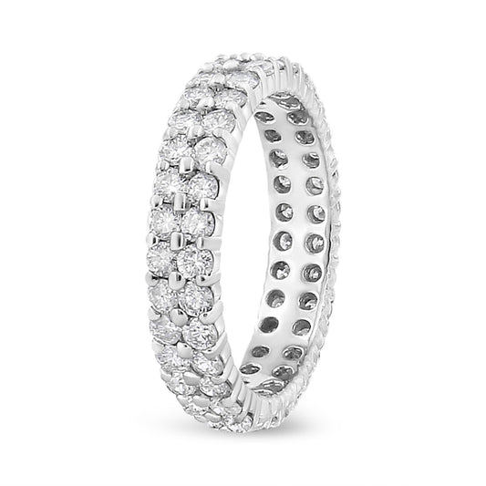 White metal ring with multiple rows of round white gemstones in prong settings, shown at a slight angle.