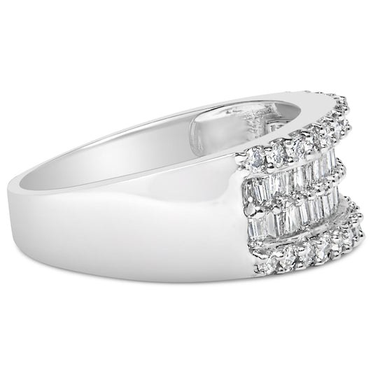 White metal ring shown at side angle with rows of round and baguette white gemstones in prong and channel settings on top.