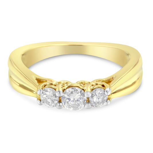 Yellow metal ring with three round white gemstones in prong setting, front-facing angle.