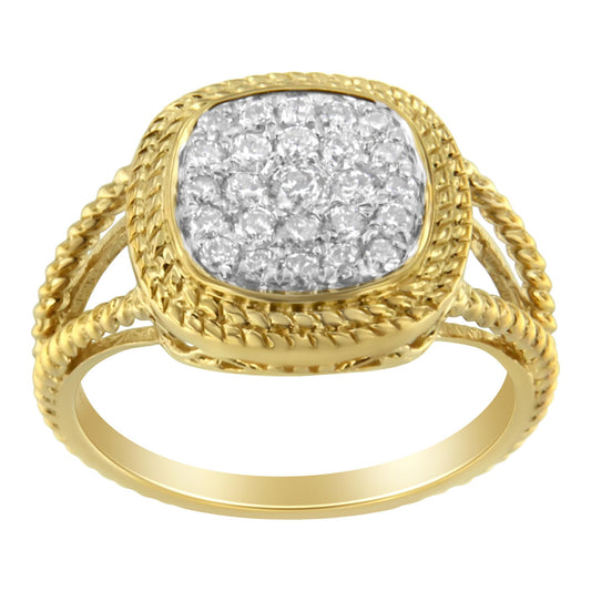 Front angle view of a yellow metal ring with a square cluster of round white gemstones in prong setting and a braided band design.