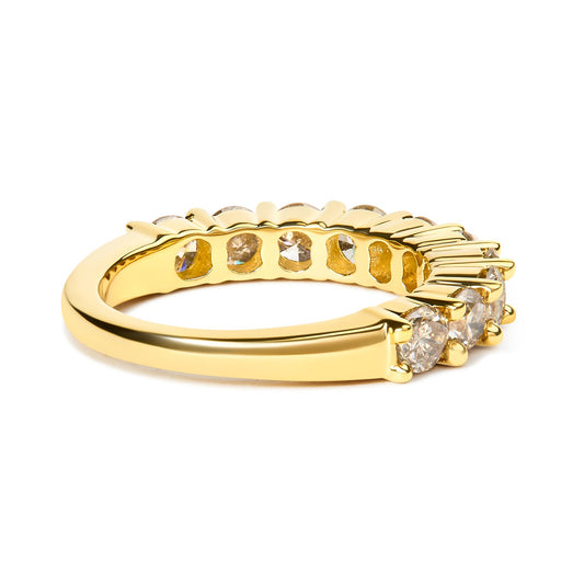 Yellow metal ring with round white gemstones in shared prong setting, shown from a side angle.