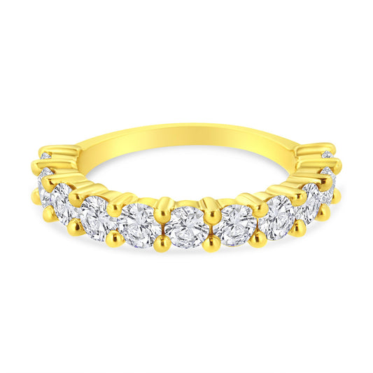 Close-up front angle of a yellow metal ring featuring a row of round white gemstones in prong settings.