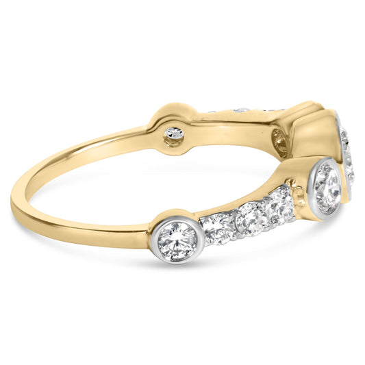 Close-up side view of a yellow metal ring featuring multiple round white gemstones with a mix of bezel and prong settings.