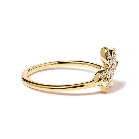 Side angle view of a yellow ring with a flower-shaped head adorned with white round gemstones in pave setting.