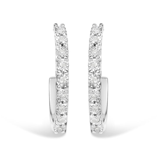 Front-facing close-up of white metal hoop earrings with round white gemstones set along the outer edge in a miracle setting.