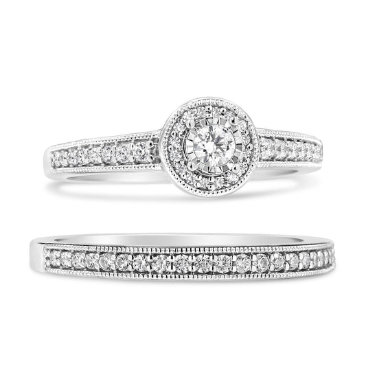 Close-up front angle of two white metal rings, one featuring a central round white gemstone in a miracle setting surrounded by smaller white gemstones in pave settings along the band, and the other ring with a band fully adorned with white gemstones in pave settings.