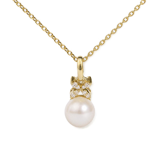 Close-up front view of a yellow metal necklace with a pendant featuring white gemstones and a large round pearl, shown on a white background.