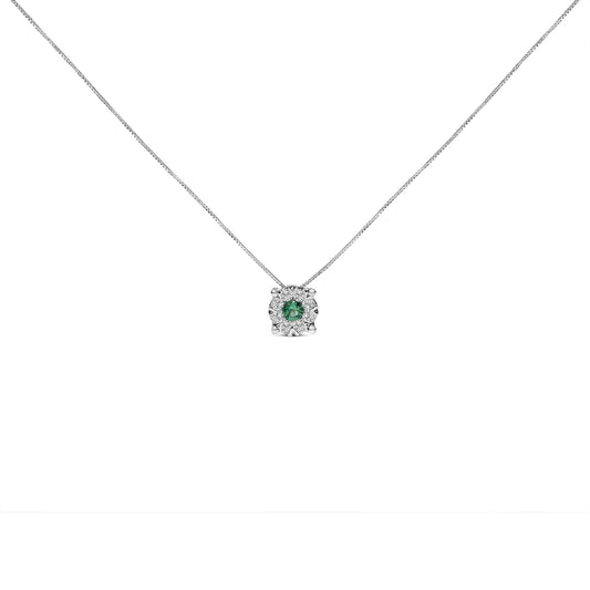 Front-facing shot of a white metal necklace with a pendant featuring a round green gemstone in a prong setting, surrounded by eight round white gemstones in a pave setting.