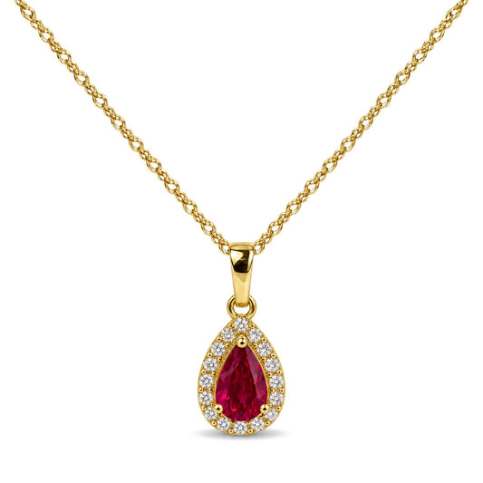 Close-up front view of a yellow metal necklace with a pear-shaped red gemstone pendant surrounded by small white gemstones in prong settings.