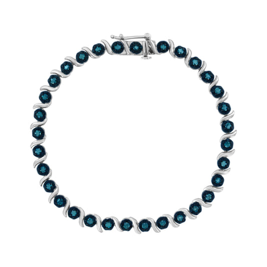 Top-down view of a white metal bracelet with round blue gemstones in prong settings, arranged in an alternating pattern.