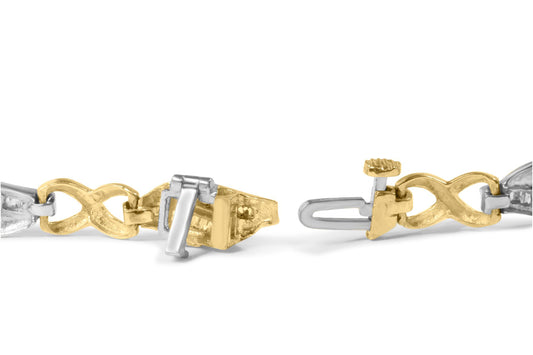 Close-up side angle of a yellow and white metal bracelet clasp with intertwined links, showing detailed locking mechanism.