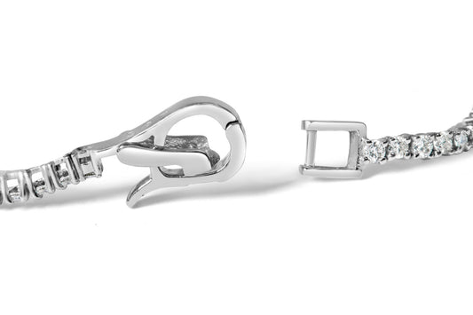 Close-up front angle of a white metal bracelet clasp with round and baguette-shaped white gemstones in prong and channel settings.