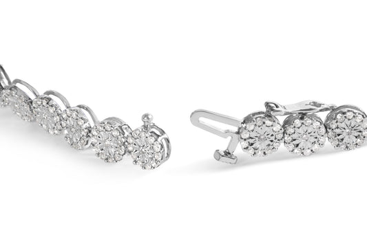 Close-up angled shot of a white metal bracelet featuring round pave-set white gemstones in circular clusters with a clasp visible.