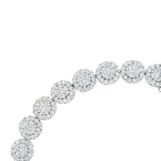 Close-up angled view of a white metal bracelet featuring multiple round clusters of white gemstones in prong settings.
