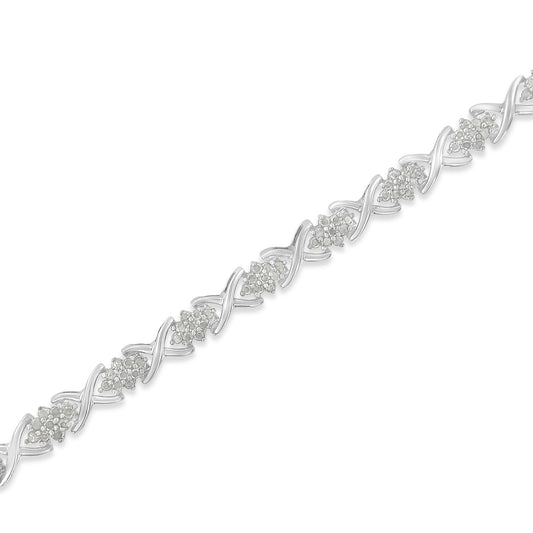 White metal bracelet with alternating clusters of round white gemstones and X-shaped links, shown in a diagonal close-up shot.