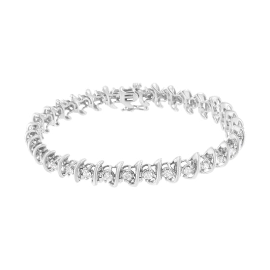 White metal bracelet with alternating small and larger round white gemstones in prong settings, shown from a slightly elevated front angle.