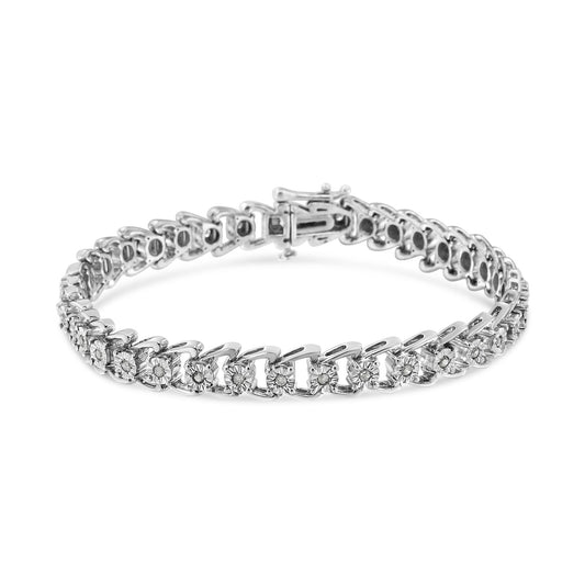 White metal bracelet with round white gemstones in a miracle setting, photographed from a front angle on a white background.