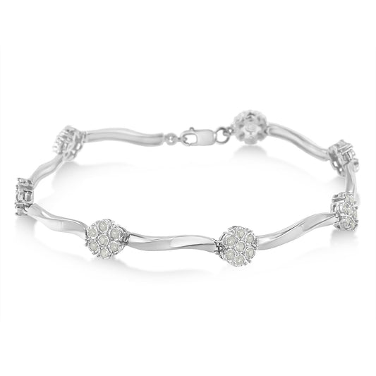 White metal bracelet with round white gemstones in miracle setting, shown in a close-up angled shot on a white background.