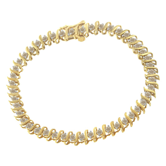 Yellow metal bracelet with round white gemstones in prong settings viewed from above.