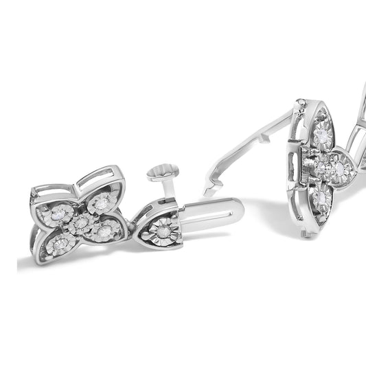 Close-up front angle of a white metal bracelet with butterfly-shaped elements adorned with round white gemstones in miracle settings.