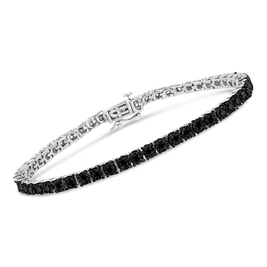 White metal bracelet with a row of round black gemstones in miracle setting, shown at an angled view.