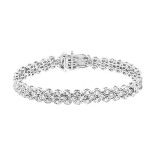 White metal bracelet with multiple round white gemstones in a pave setting, shown in a side view on a white background.