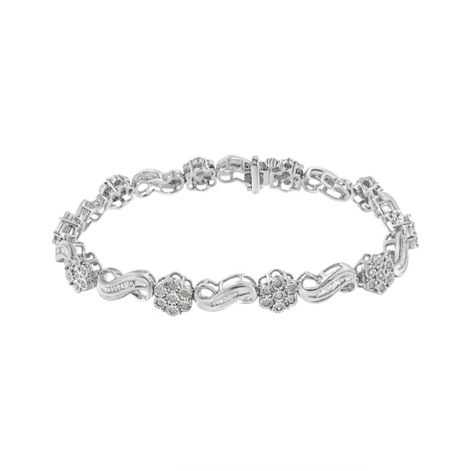 White metal bracelet with alternating floral clusters of round white gemstones in miracle setting and wavy links set with baguette white gemstones in channel setting, shown from a top angle against a white background.