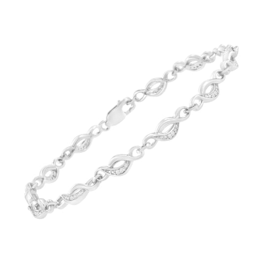 White metal bracelet with alternating twisted links, each set with small round white gemstones in prong settings, shown from a slightly angled top view.