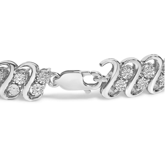 Close-up side angle of a white metal bracelet featuring a wavy design with round white gemstones in miracle settings and a lobster clasp.