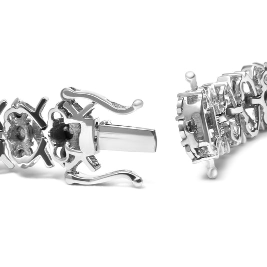 Close-up side angle of a white metal bracelet clasp showing two sections with round white gemstones in miracle settings.