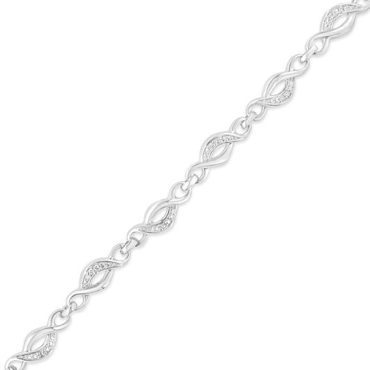Diagonal close-up of a white bracelet with intertwined links, each featuring small white gemstones in a prong setting.