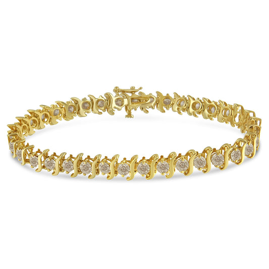 Yellow metal bracelet with round white gemstones in prong settings, shown from a slightly elevated angle.