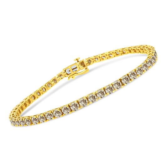 Yellow metal bracelet with brownish round gemstones in prong setting, shown at an angled close-up.