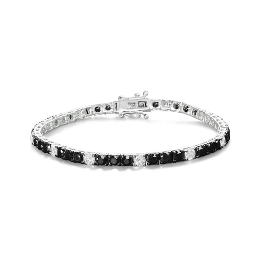 White metal bracelet with alternating black and white round gemstones in four-prong settings, shown from a slightly elevated front angle.