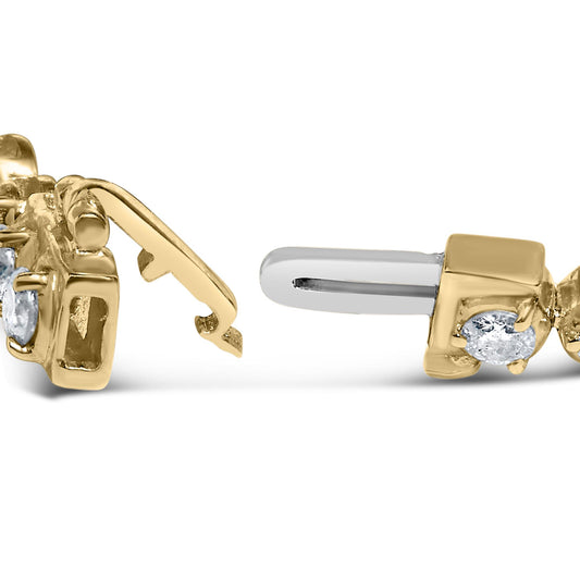 Close-up side angle of a yellow metal bracelet clasp featuring round white gemstones set in prongs.