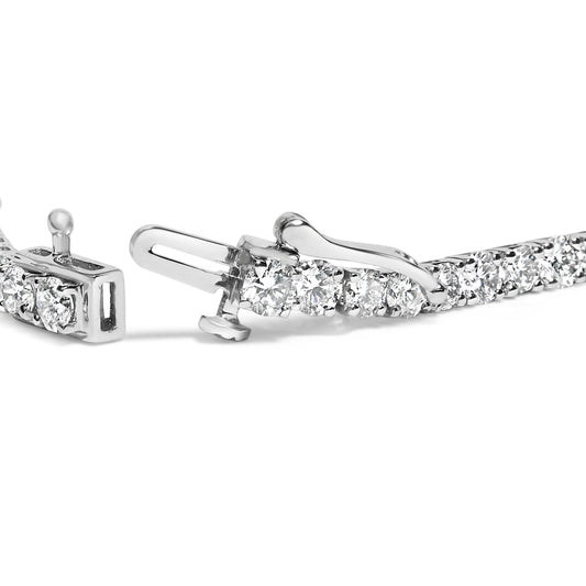 Close-up view of a white metal bracelet with round white gemstones in four-prong settings, showing the clasp mechanism.