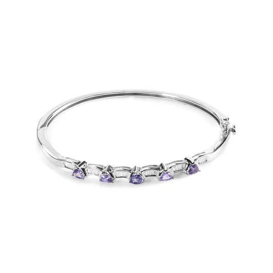 White metal bracelet shown on a white background, front angle view, featuring alternating blue trillion-shaped gemstones in prong settings and white baguette-shaped gemstones in channel settings.