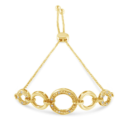 Yellow metal bracelet with alternating oval and round links, some adorned with round white gemstones in pave setting, shown from a front angle.