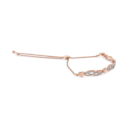 Rose-colored bracelet with heart shapes and intertwined design adorned with white pave-set round gemstones, shown from a side angle.