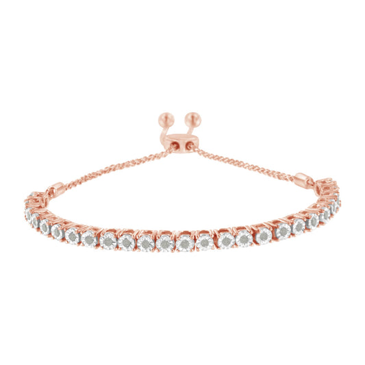 Close-up front angle of a rose metal bracelet featuring a row of round white gemstones in miracle settings with an adjustable sliding clasp.