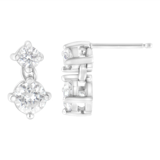 Pair of white metal stud earrings with prong-set round white gemstones in a vertical double design, shown from front and side angles.